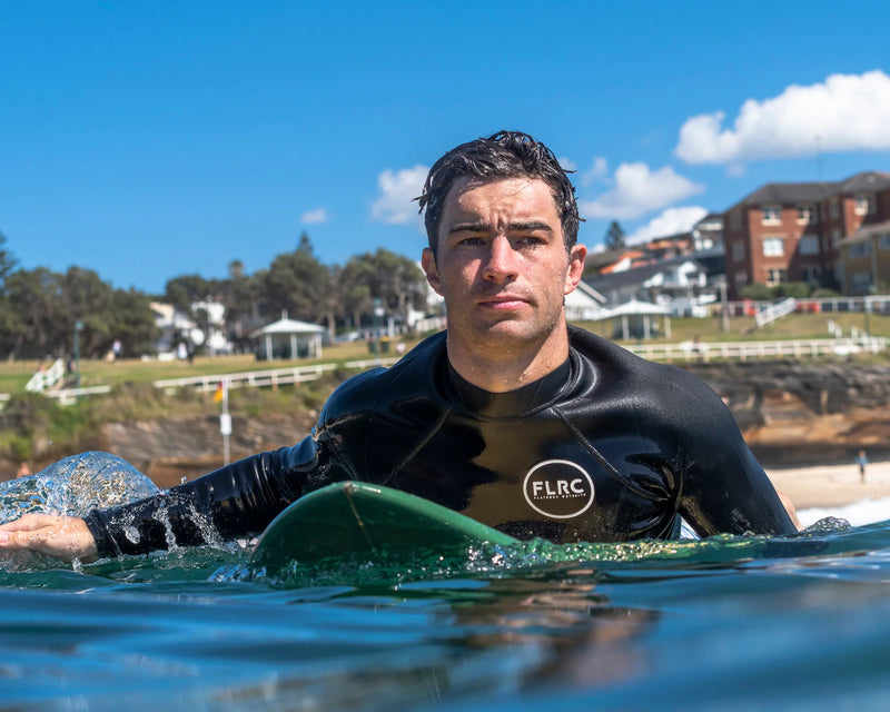 Men's 1.5mm black wetsuit top shown while paddling